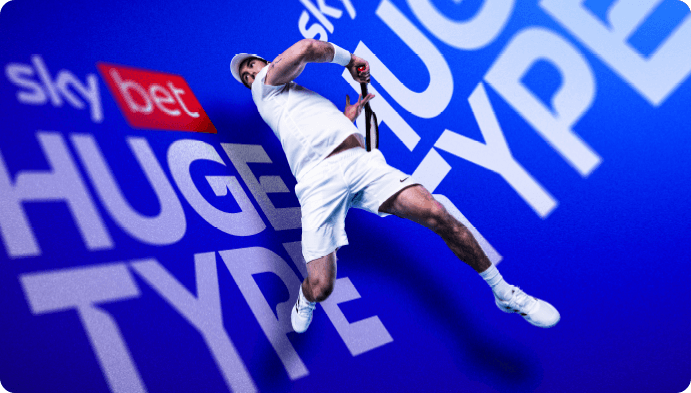 A tennis player mid-serve with the words HUGE TYPE set behind and around him, sharing the depth of the scene.